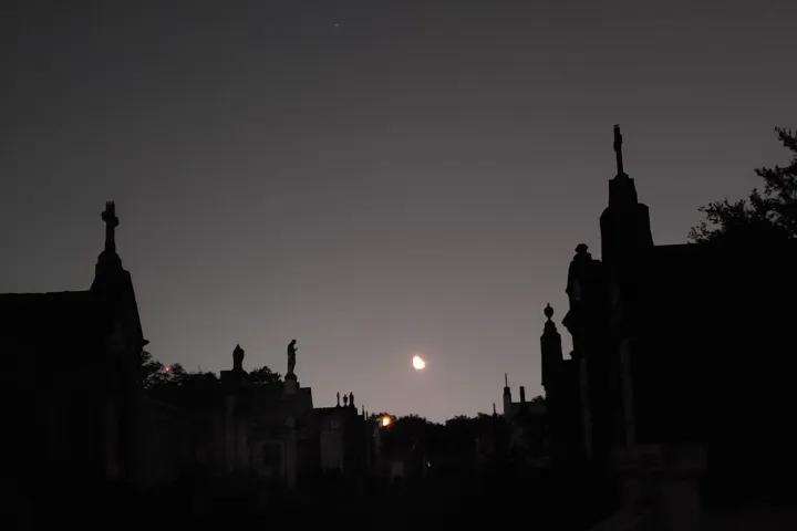 a large clock tower towering over a city at night