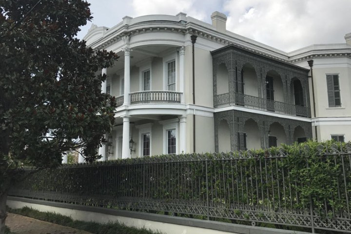 a large brick building with grass and trees