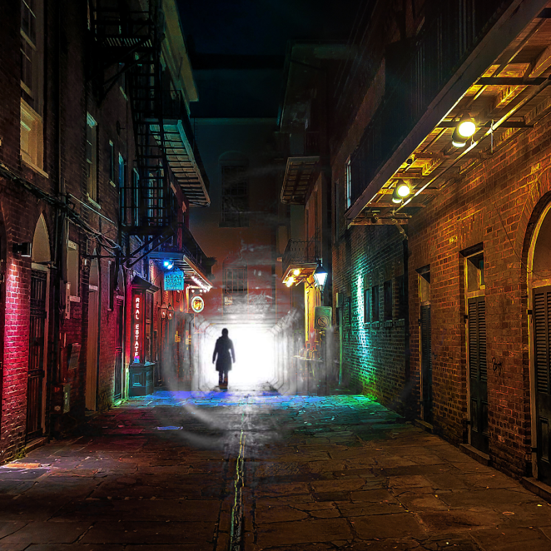 a brick building with graffiti on the side of the street